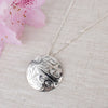 Sterling silver northwest coast hummingbird pendant with pink flower in the corner
