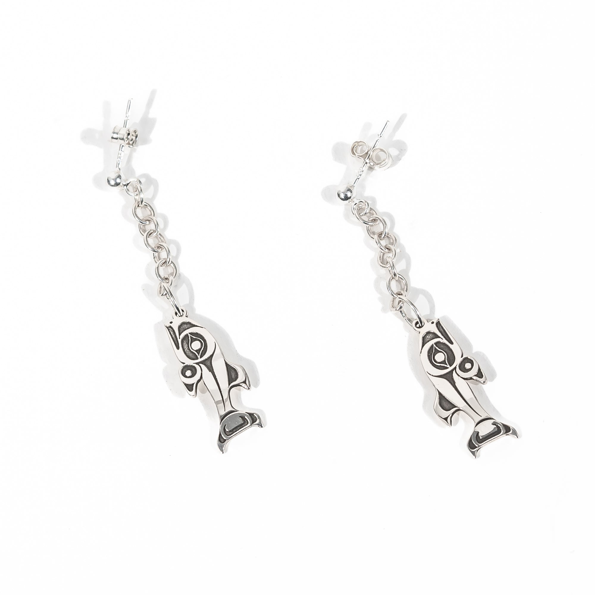 Angled Sterling Silver Stud Earrings with chain dangles and a NOrthwest Coast style salmon charm on a white back ground by Ts'msyen artist Morgan Asoyuf