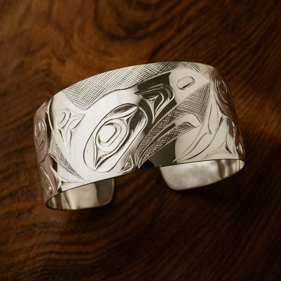 Men's 1.5 inch wide sterling silver raven bracelet by northwest coast Haida artist James Sawyer. Sold by Crystal Cabin Gallery on Haida Gwaii.