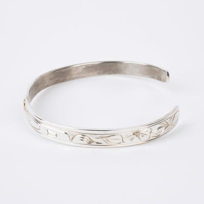 Side flower view of Sterling Silver Bracelet with flowers and a 14k gold hummingbird formline head made by first nations artist Agnes Seaweed Wisden