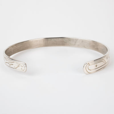 Back view Sterling silver Bracelet featuring  14k gold formline orca head, with mountains, ocean, sun, and trees hand carved around the bracelet