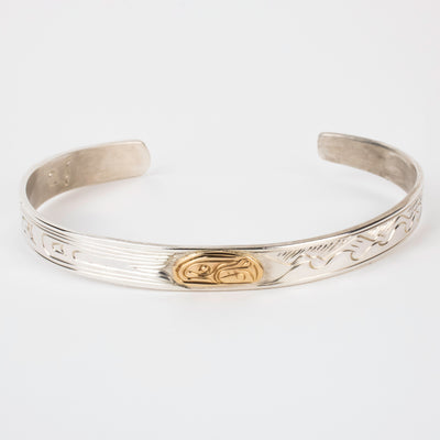 Sterling silver Bracelet featuring  14k gold formline orca head, with mountains, ocean and trees hand carved around the bracelet
