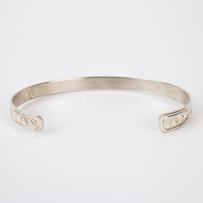 Back view of mountains on Sterling silver Bracelet featuring  14k gold formline eagle head, with mountains and trees hand carved around the bracelet