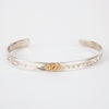 Sterling silver Bracelet featuring  14k gold formline raven steals the light head, with mountains and trees hand carved around the bracelet