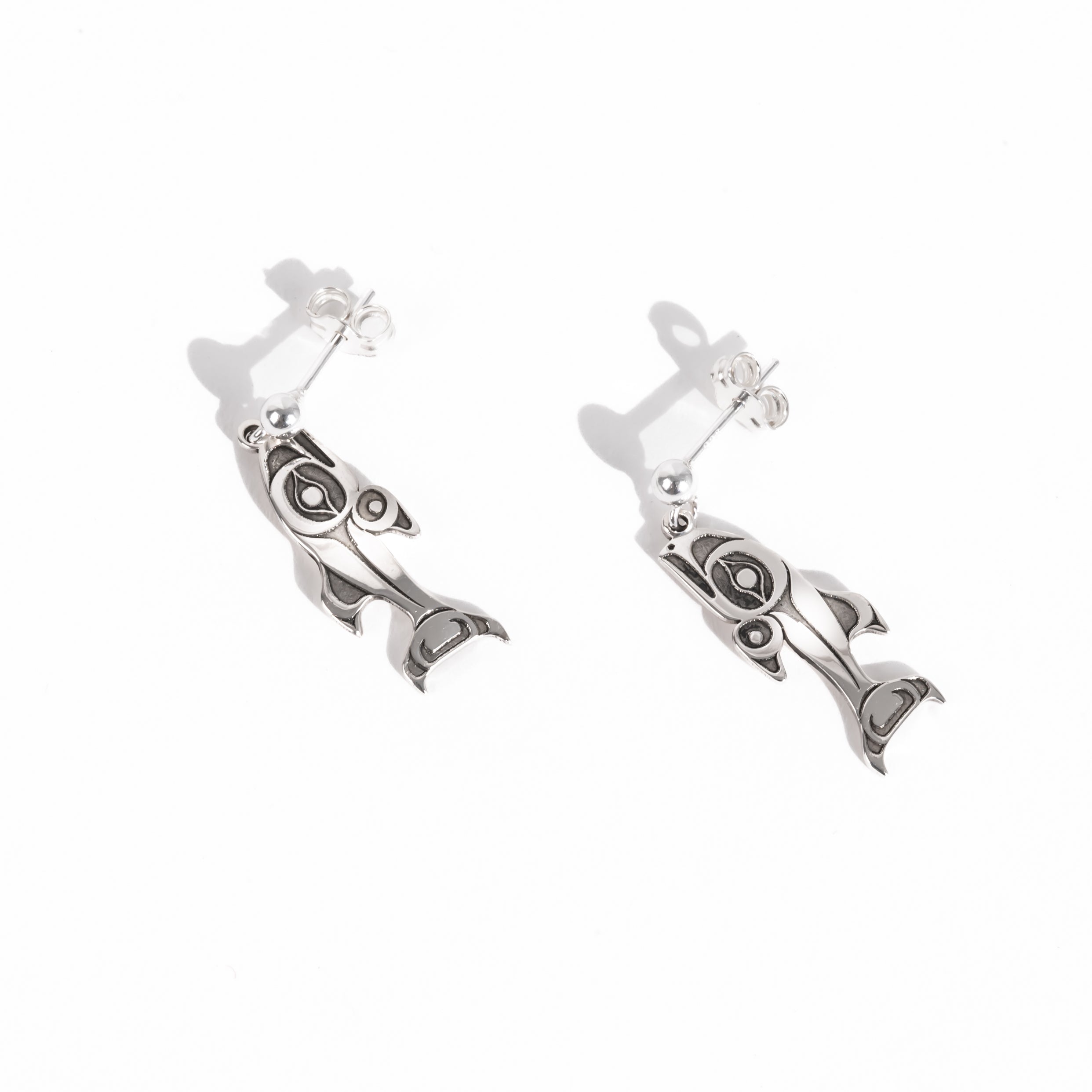 Sterling Silver Salmon earrings on a white background by Native artist Morgan Asoyuf