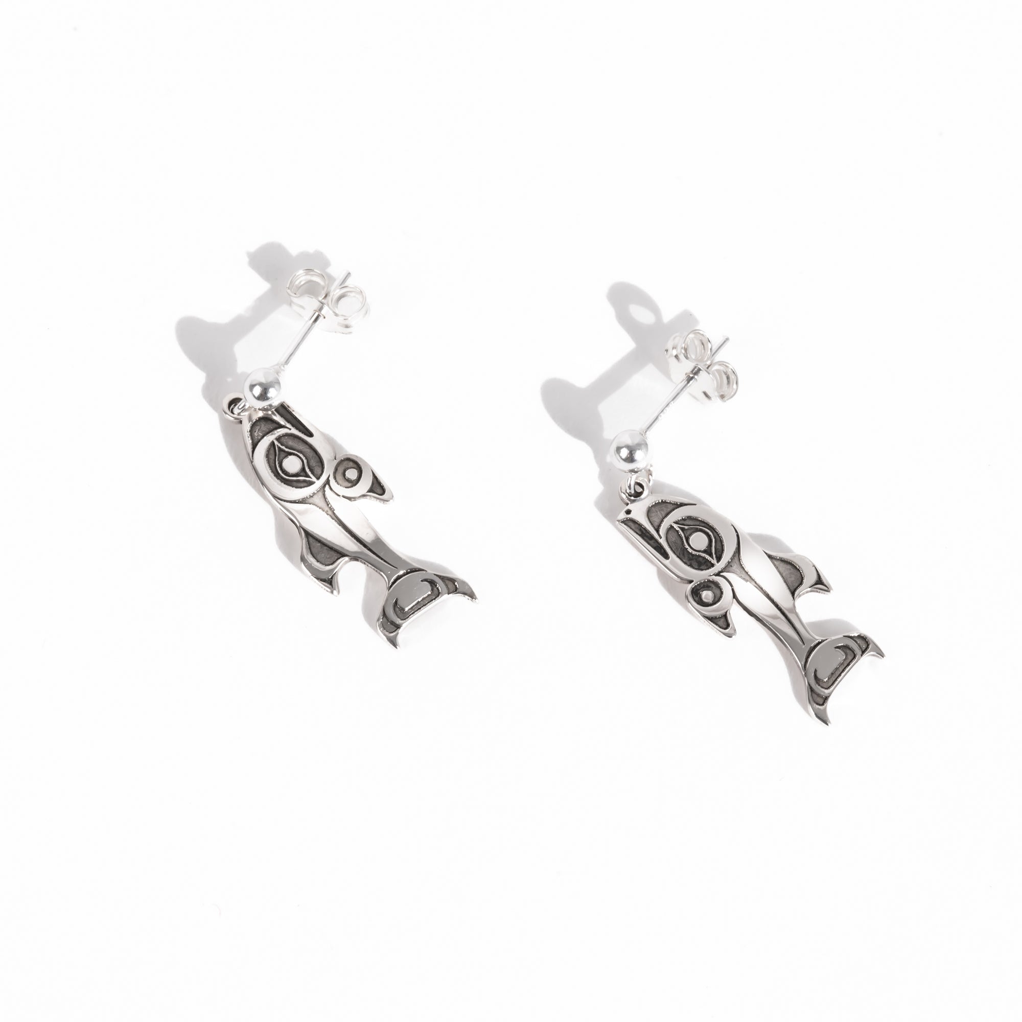 Sterling Silver Salmon earrings on a white background by Native artist Morgan Asoyuf