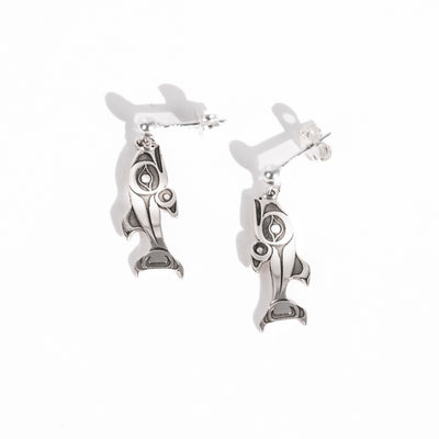 Sterling Silver Salmon dangle stud earrings on a white background by Native artist Morgan Asoyuf with oxidized silver formline details