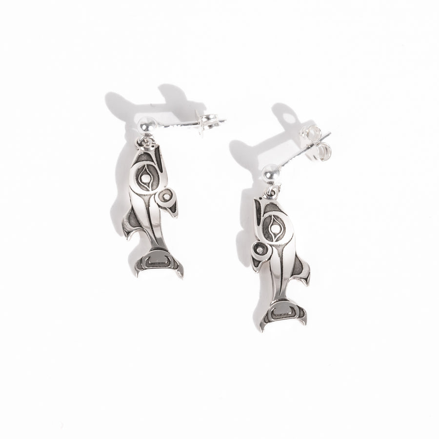 Sterling Silver Salmon dangle stud earrings on a white background by Native artist Morgan Asoyuf with oxidized silver formline details