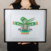Model holding hummingbird art print for size ratio