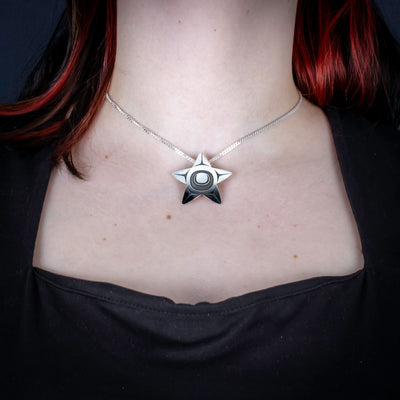 Sterling Silver Starfish Pendant by Canadian Handpoke tattoo artist Danika worn by a model