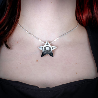 Sterling Silver Starfish Pendant by Canadian Handpoke tattoo artist Danika worn by a model