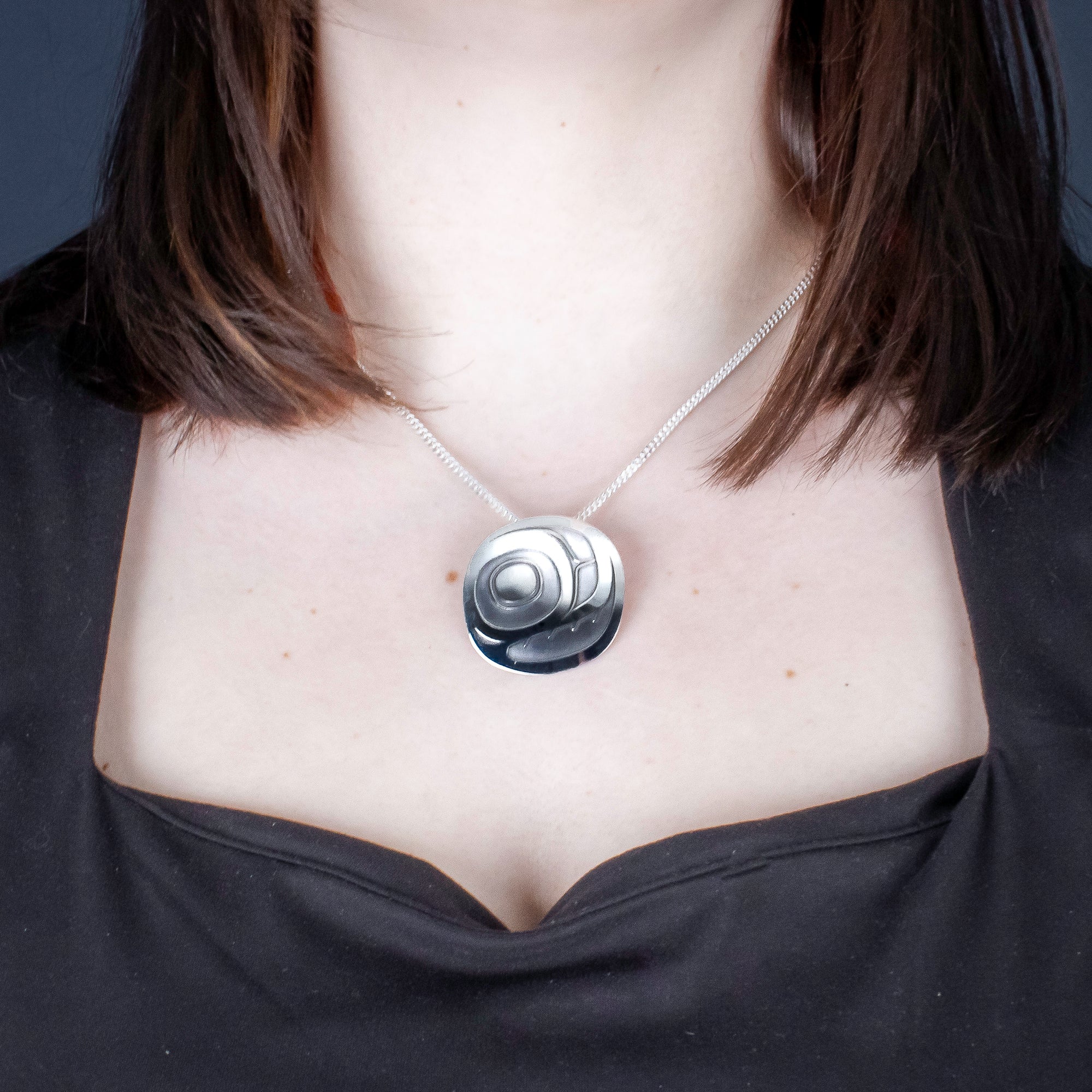Sterling Silver Salmon Egg Pendant by Canadian Handpoke tattoo artist Danika worn by a model