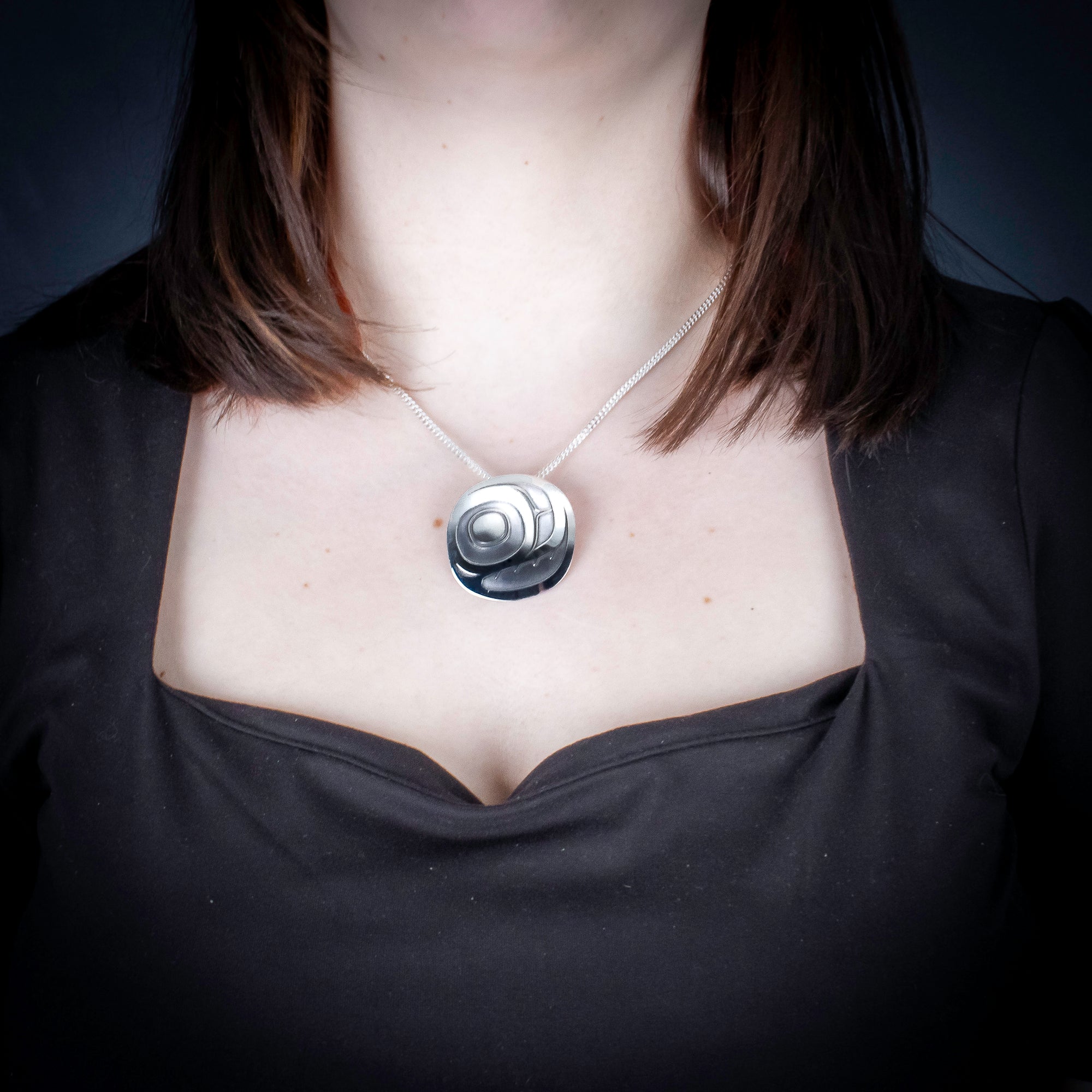 Sterling Silver Salmon Egg Pendant by Canadian Handpoke tattoo artist Danika worn by a model