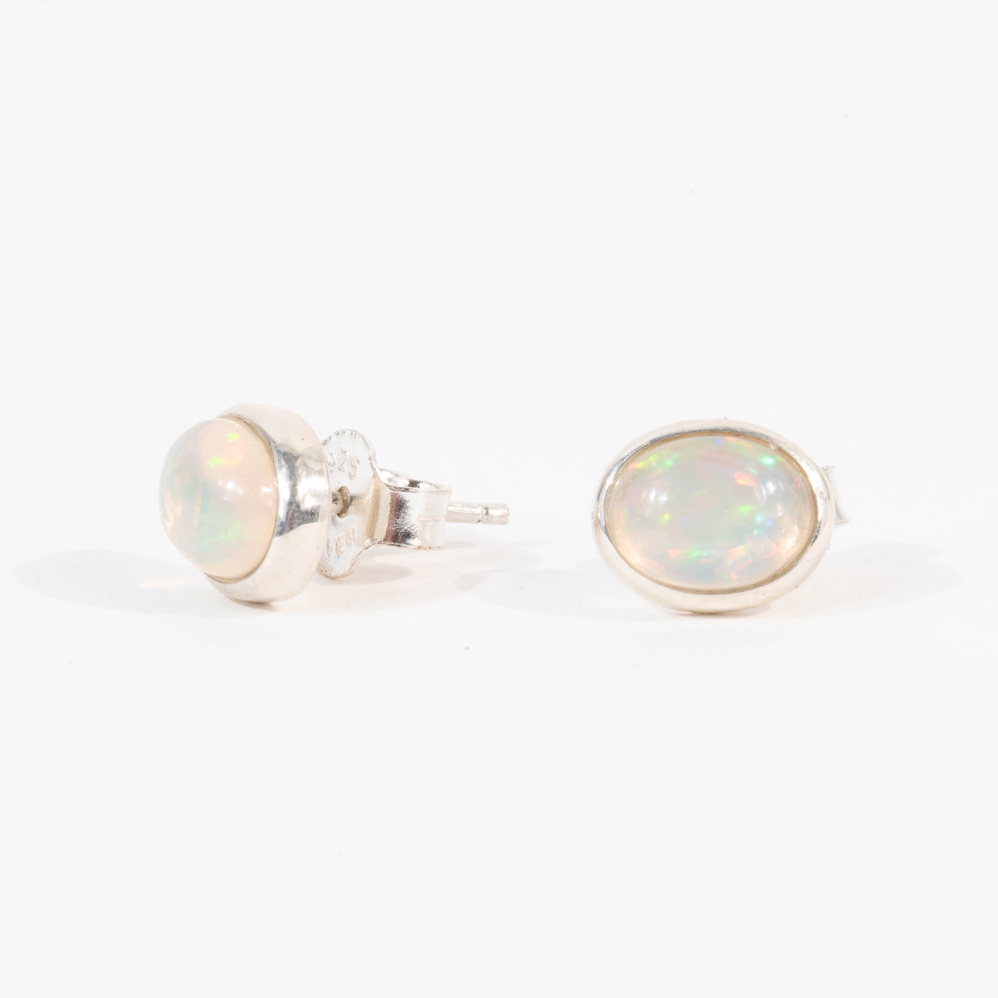 Pair of opal stud earrings on a white background
