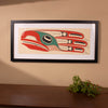 Framed fine artwork of a stylized bird with red, green, and black colors on a beige background by Haida Artist Robert Davidson