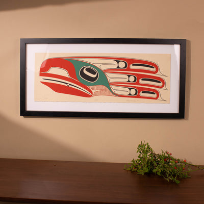 Framed fine artwork of a stylized bird with red, green, and black colors on a beige background by Haida Artist Robert Davidson