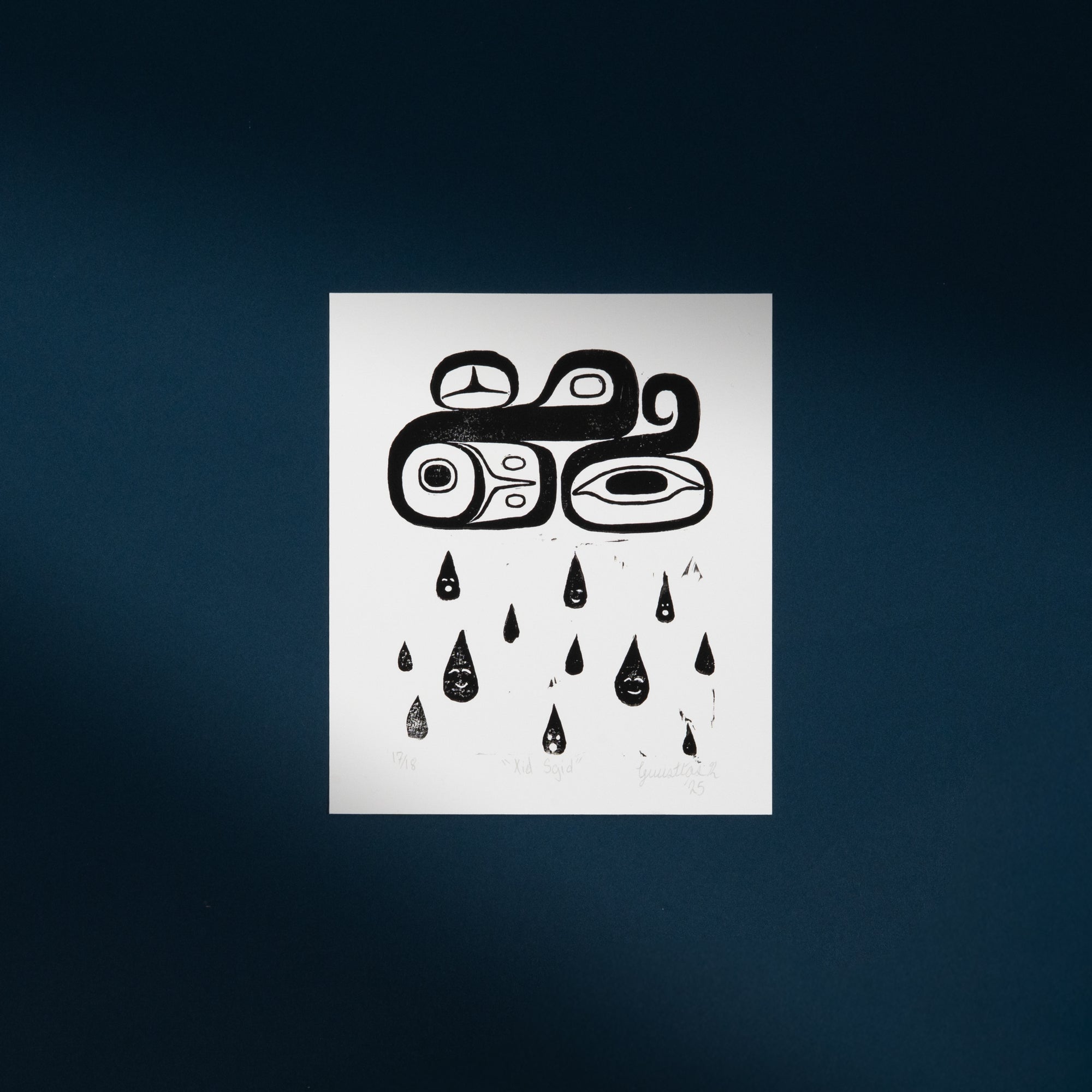 Black and white abstract Haida design on a white art print  against a dark blue background