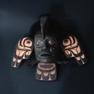 Decretive northwest coast wall hanging with black face and wings.