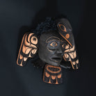 Articulated raven Haida art mask by Corey Bulpitt on a black background.