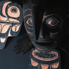 Close up of carved face with bird beak.
