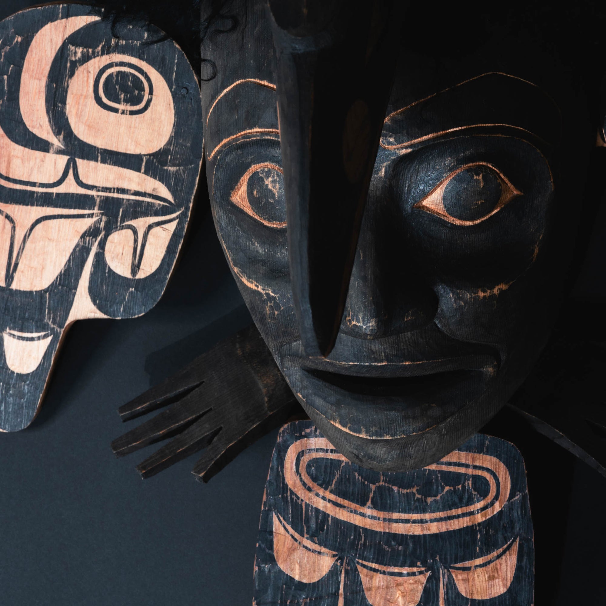 Close up of carved face with bird beak.