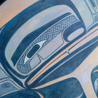 Close-up of blue and purple raven face of painted panel.