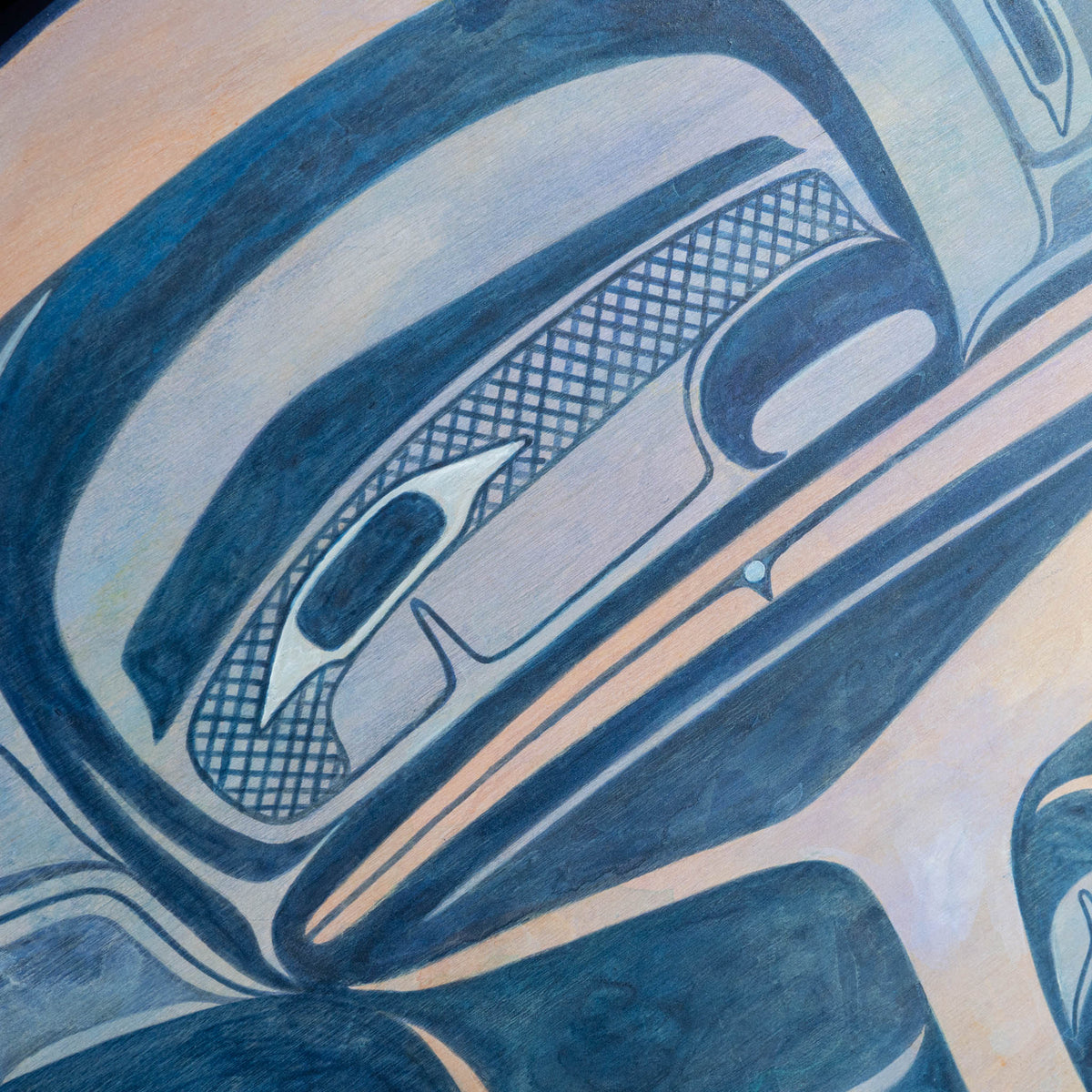 Close-up of blue and purple raven face of painted panel.