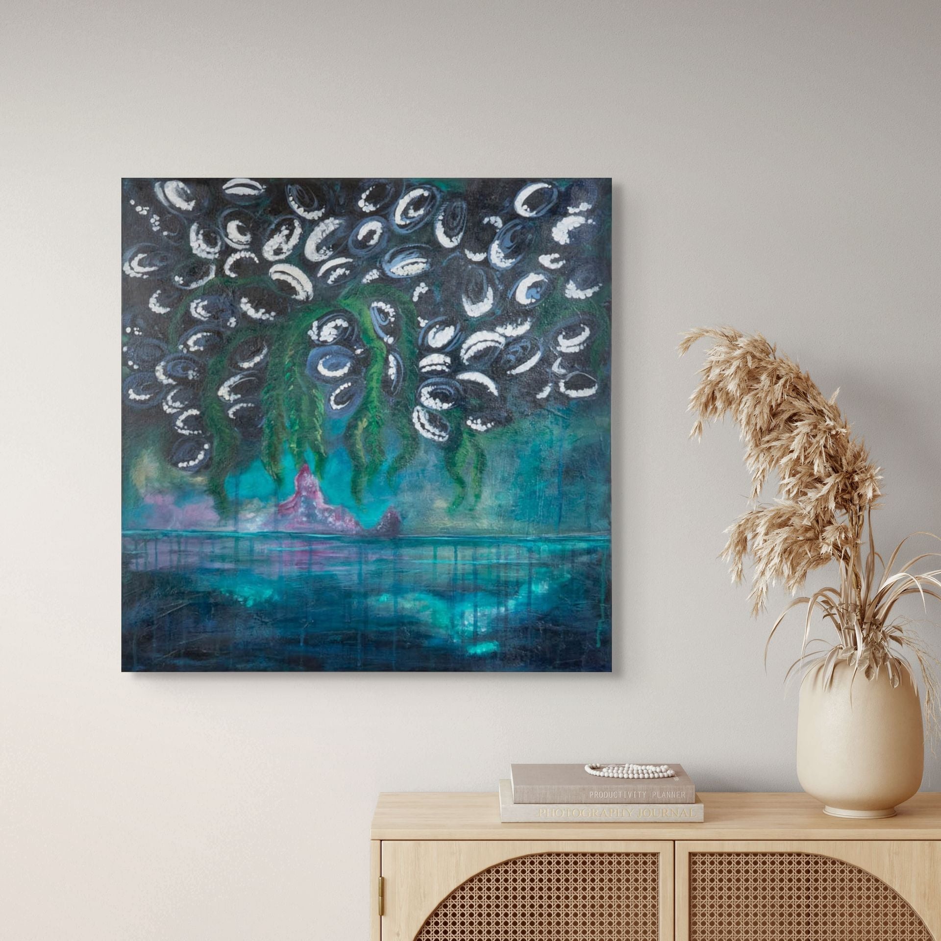 Barnacles Gwaii Haanas painting to the left of a wicker desk and dried plants