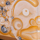 Abstract painting featuring a stylized half face, rendered in warm beige, orange, and white tones with circular and spiral patterns.