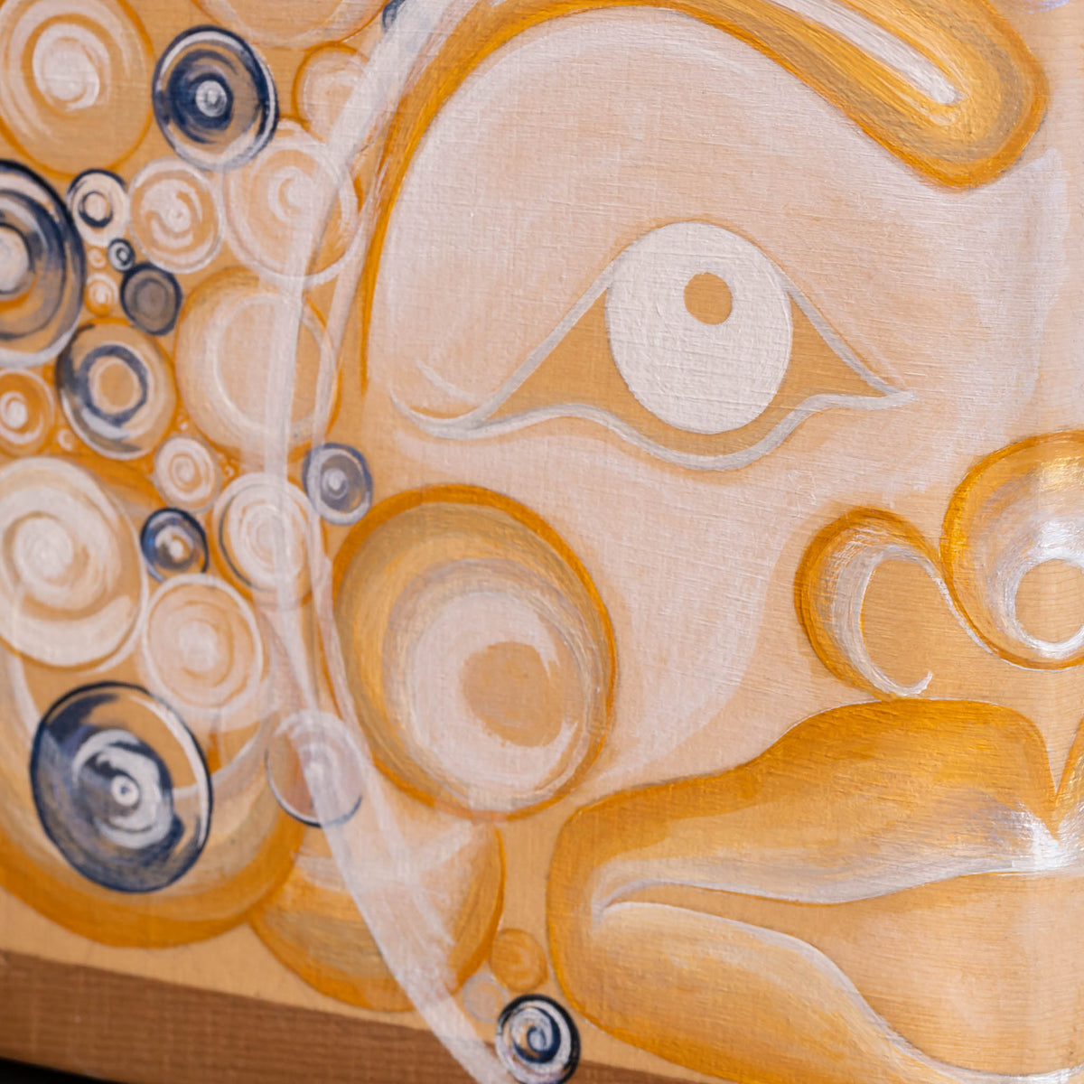Abstract painting featuring a stylized half face, rendered in warm beige, orange, and white tones with circular and spiral patterns.