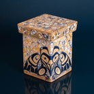 Decrotive wooden box painted with formline raven in blue and black, and bubbles in blues whites and yellows, on a blue back ground