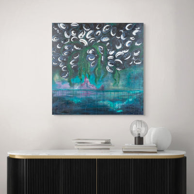 A blue and green acrylic painting on a white wall with a black desk underneath.
