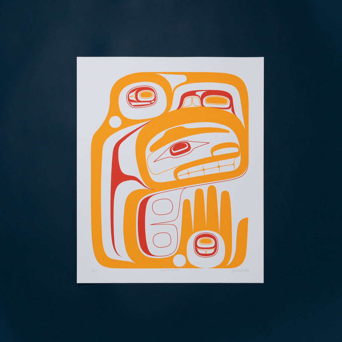 A rectangle Haida art print featuring a stylized Indigenous Northwest design in orange, red, and white, centred against a dark navy blue background.