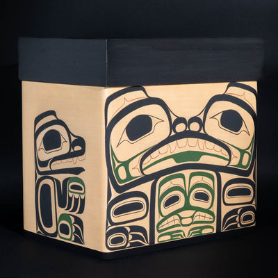 An original hand painted bentwood box design featuring the narrative of bear mother in black, green, and copper and formline painted by Daisy White and fabricated by Reg Davidson. on a black background