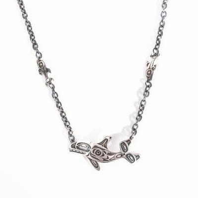 Sterling Silver Killer whale and salmon necklace hand made by Ts'msyen artist Morgan Asoyuf on a white background