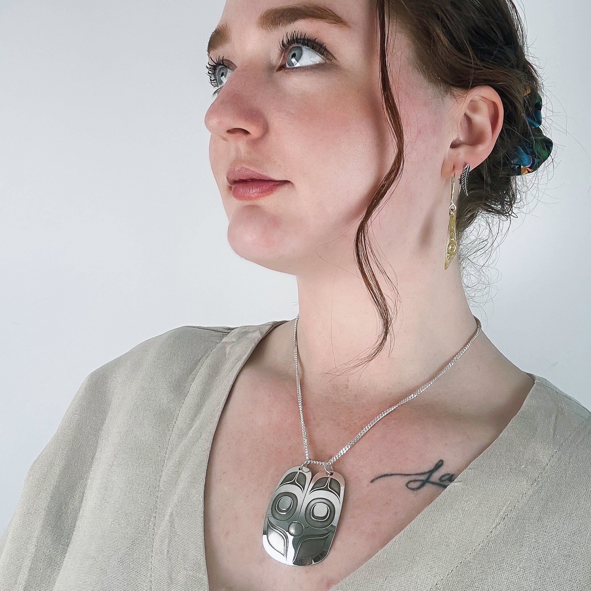 Sterling Silver Mouse Woman Pendant, by Danika Saunders Nuxalk artist and jeweller, worn by model life style photo