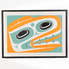 Black Framed artwork of a stylized Haida Formline Halibut face with orange, green, and black colors framed and ready to hang by Cori Savard