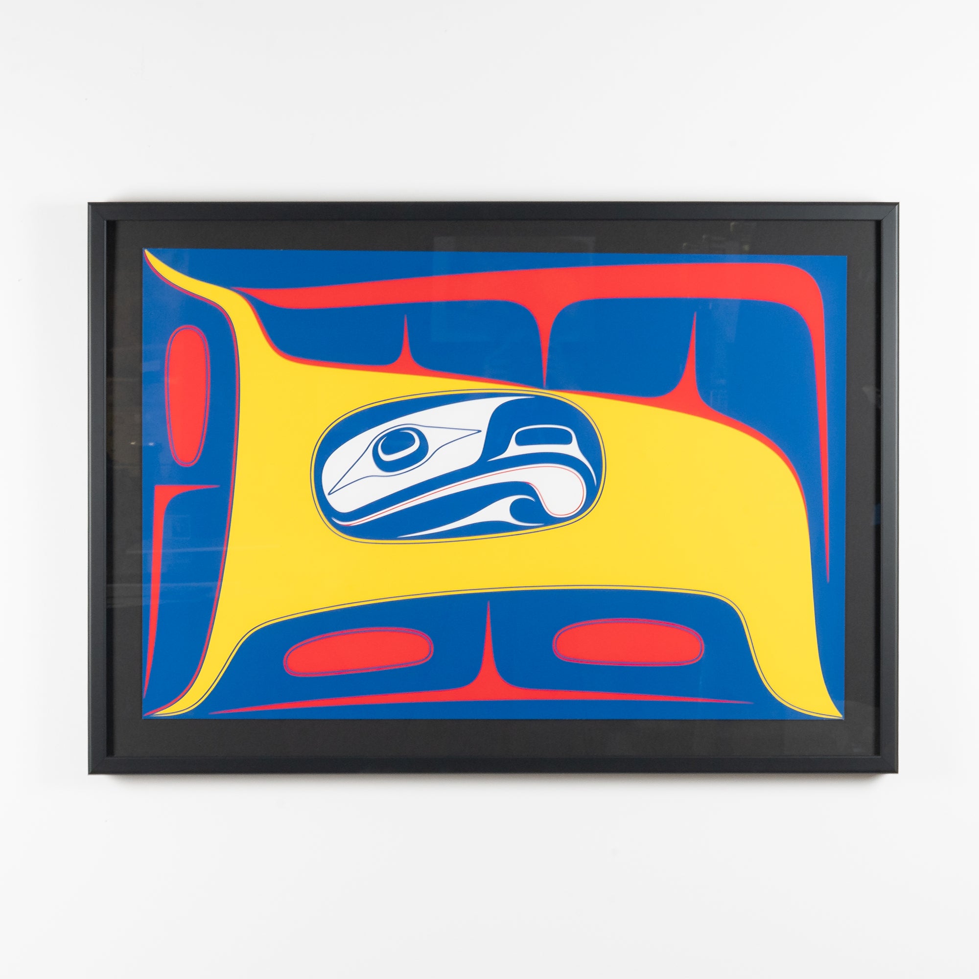 Framed fine artwork with a stylized formline design featuring a blue and white abstract eagle figure with yellow and red background by renowned haida artist Robert Davidson