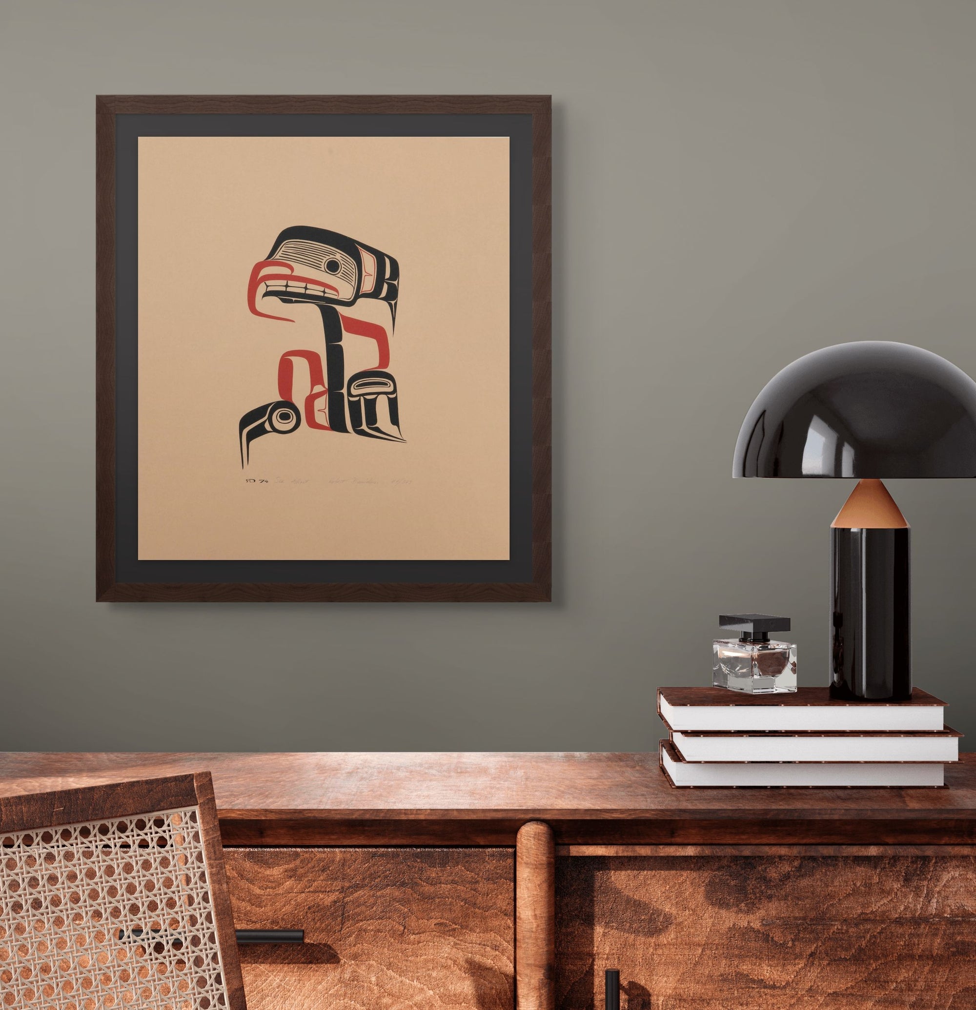 Framed artwork on a wall above a wooden console table with decorative items.