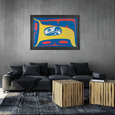 Modern living room with a gray sofa, abstract Framed fine artwork with a stylized formline design featuring a blue and white abstract eagle figure with yellow and red background by renowned haida artist Robert Davidson on the wall, and wooden side tables.