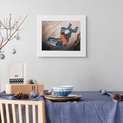 Framed fine art print a moment to vanish created by local haida artist Shoshannah Greene featuring a girl riding a formline killer whale through a kelp bed above a table with decorative items