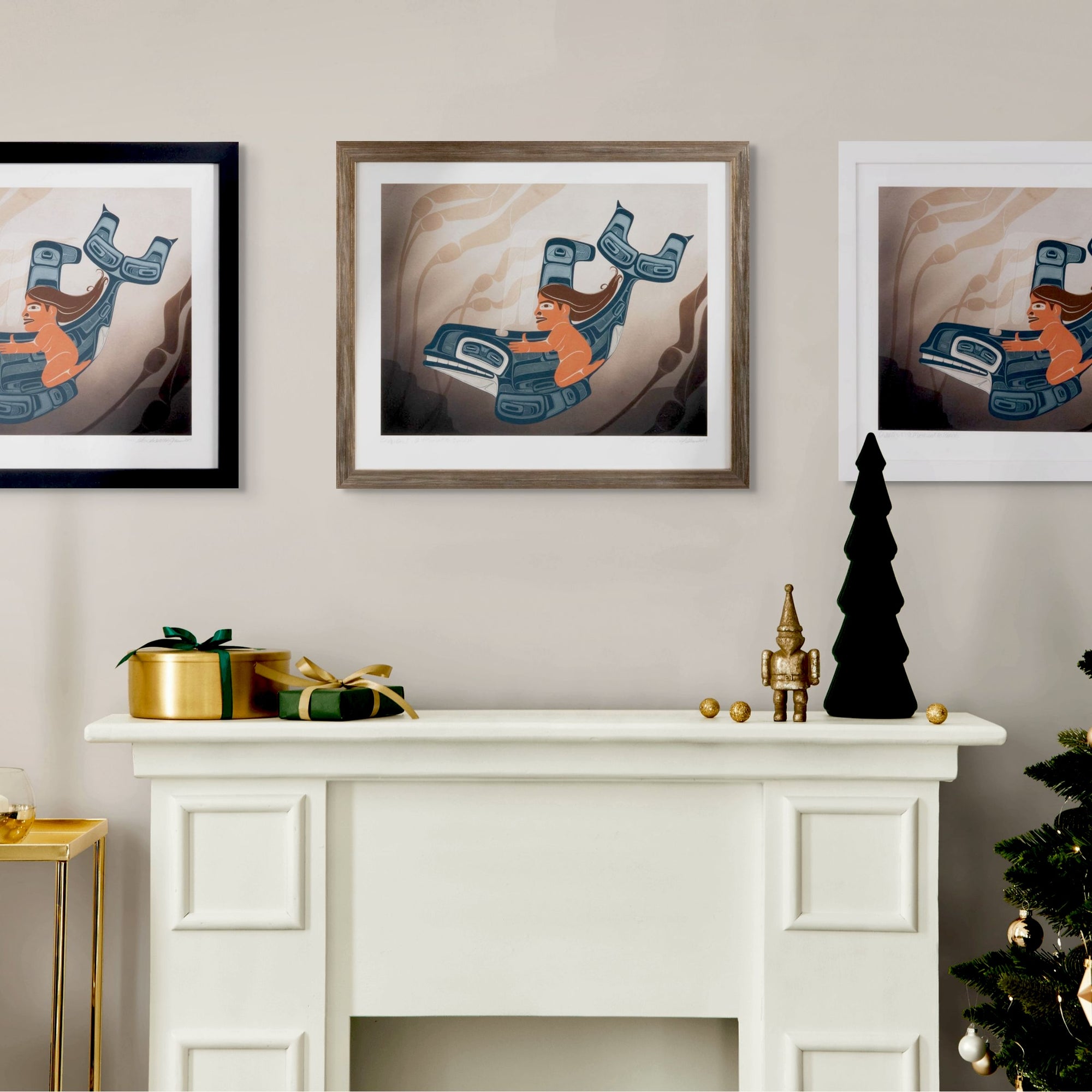 Framed fine art print a moment to vanish created by local haida artist Shoshannah Greene featuring a gilr riding a formline killer whale through a kelp bed on a wall above a white fireplace with decorative items.
