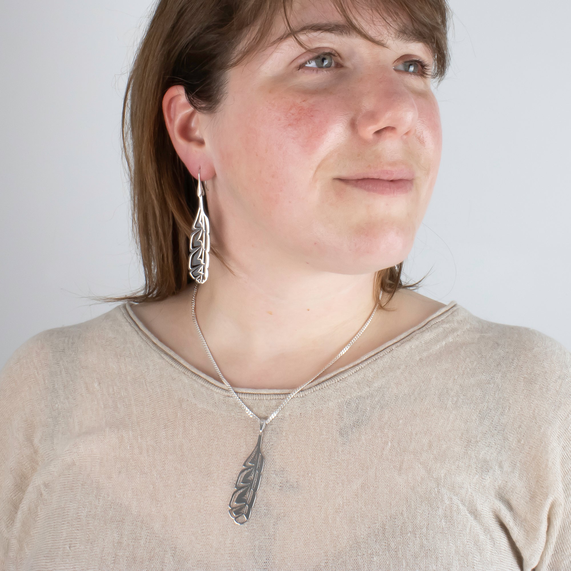 Laser engraved Sterling silver feather earrings, made by First nations artist, with matching pendant