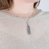Laser engraved Sterling silver feather pendant, made by First nations artist, on model