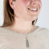 Laser engraved Sterling silver feather pendant, made by First nations artist, on model