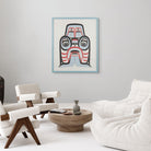 Blue black and red painting of a Haida dogfish mother in a blue frame in a white room with white chairs and a round wood table.