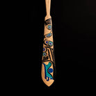 Tip of 'The Wayfinder' Haida Paddle Art by Billy Yovanovich on lack background.