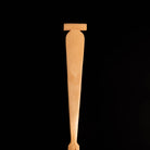 Wooden paddle handle a black background.