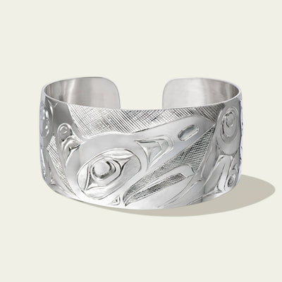 Men's 1.5 inch wide sterling silver raven bracelet by northwest coast Haida artist James Sawyer. Sold by Crystal Cabin Gallery on Haida Gwaii.